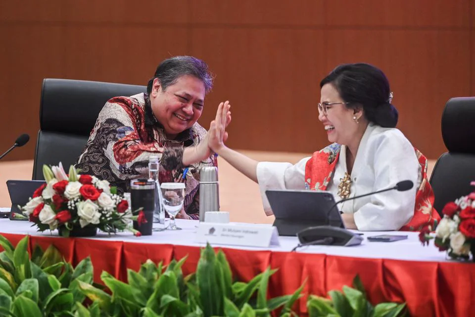 Menko Perekonomian Airlangga Hartarto (kiri) melakukan tos dengan Menteri Keuangan Sri Mulyani Indrawati (kana