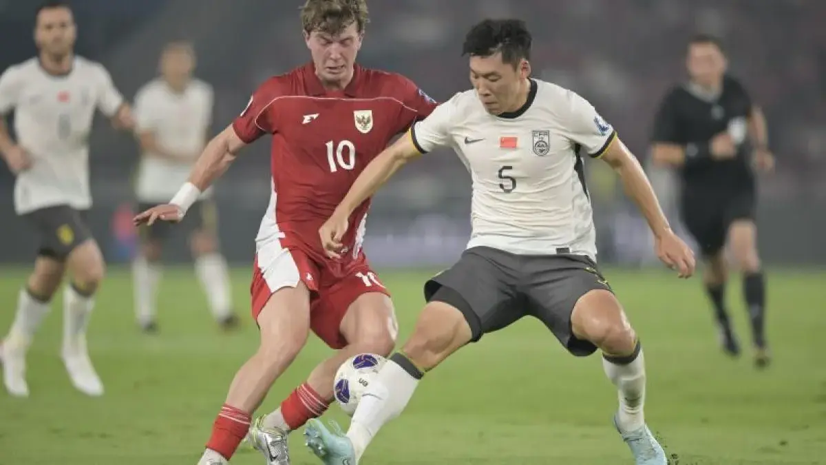 Pesepak bola Timnas Indonesia Ole Lennard Romenij (kiri) berebut bola dengan pesepak bola Timnas China Zhu Che