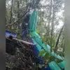 Ekor dari bangkai Helikopter BK117 D3 yang hangus terbakar dalam kecelakaan jatuh di kawasan hutan sekitar Air